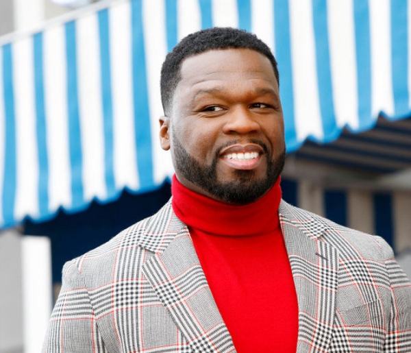 50 Cent smiling in red high neck