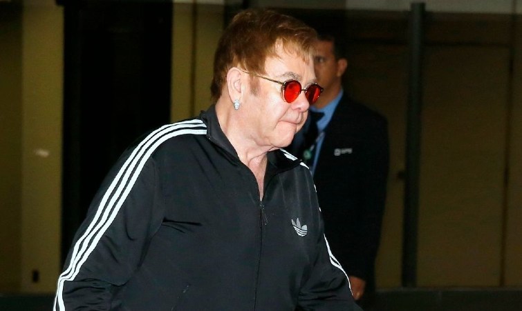 Elton John in sunglasses going somewhere