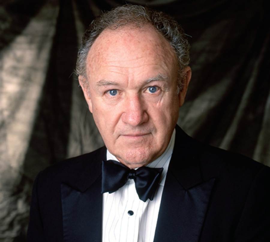 Gene Hackman in black suit and white shirt